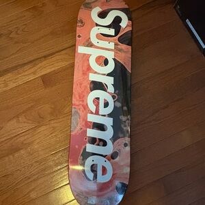 Supreme Skateboard Deck with Red and Black Swirl